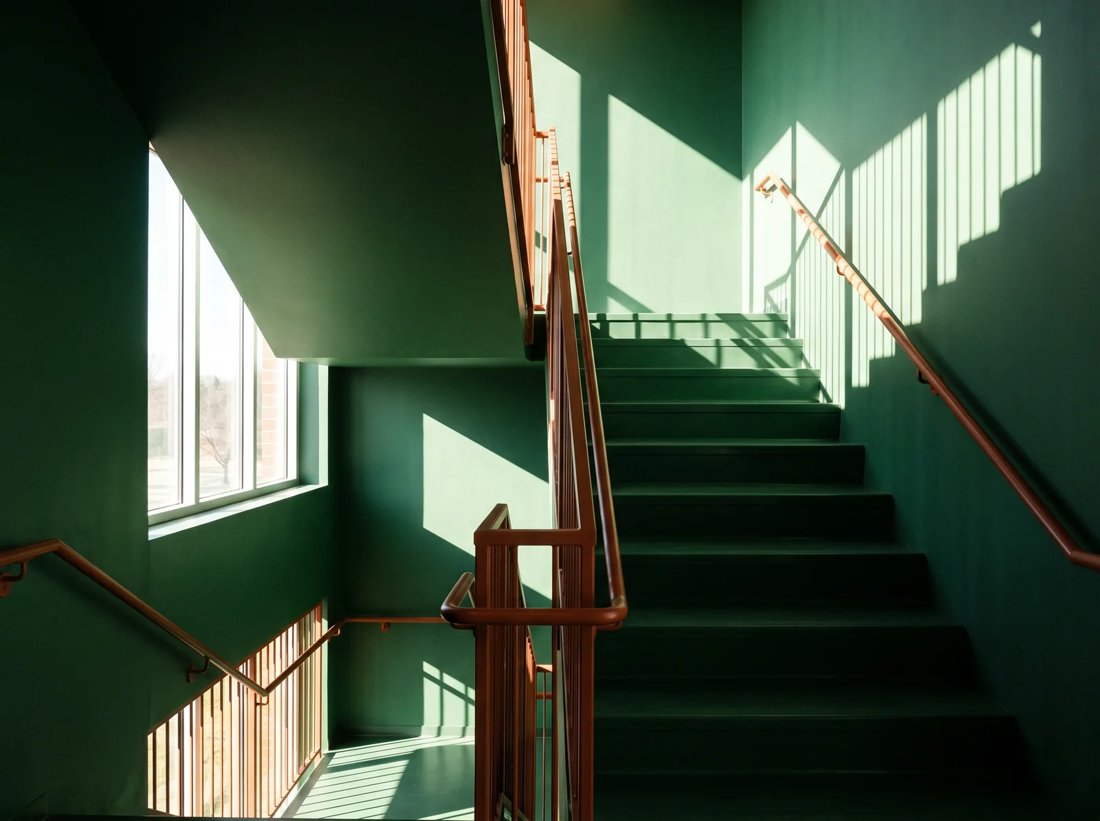 Green stairwell with geometric light